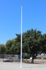 A Aluminum flagpole that was changed to white after years it being dull and ugly